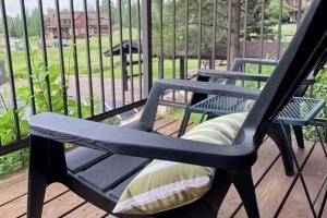 a rocking chair on a porch with a view of a yard at Rockies Condo 2407 in Steamboat Springs