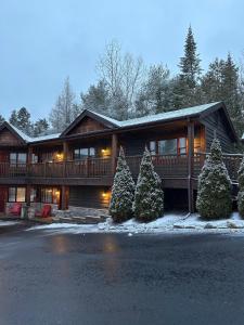 a house with christmas trees in front of it at Lake Placid Inn: Residences in Lake Placid