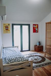 a bedroom with a bed in a room with windows at Maison Typique Landaise in Moliets-et-Maa +53 photos