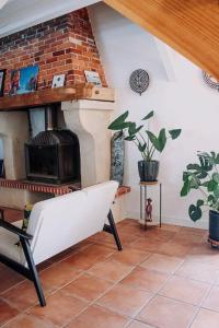 a living room with a fireplace and a couch at Maison Typique Landaise in Moliets-et-Maa