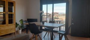 a dining table and chairs in a room with a balcony at Casa el Hierro in Lajares