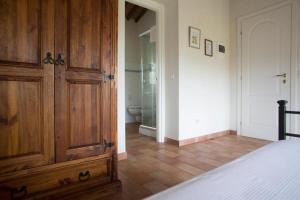 a bedroom with a wooden cabinet and a bathroom at Hotel Santo Stefano in Portoferraio