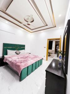 a bedroom with a bed and a ceiling at BED AND BREAKFAST ISLAMABAD - cottages in Islamabad
