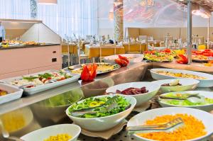a buffet line with many different dishes of food at Hotel Montecarlo in Bibione