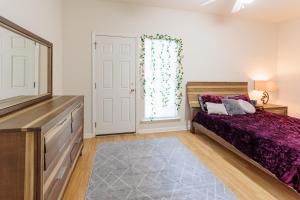 a bedroom with a bed and a dresser and a window at Private 2 bedroom and 2 bathroom in Savannah in Savannah