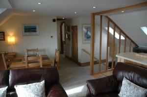 a living room with a couch and a table at Harbourside in Tobermory