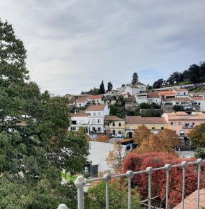 a view of a city with buildings on a hill at Casa Malva - Traditional townhouse apartment in Monchique