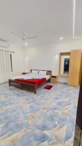 a bedroom with a bed in a room with a marble floor at MARARI GOD's OWN VILLA in Alleppey