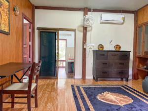 a dining room with a table and a dresser at Koh Yao Noi Garden Home in Ban Nai Khlong