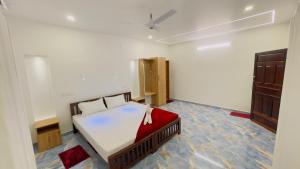 a bedroom with a bed and a wooden cabinet at MARARI GOD's OWN VILLA in Alleppey