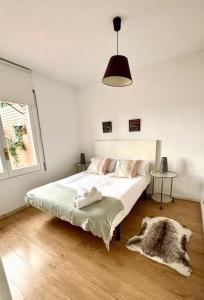 a bedroom with a white bed and a window at SANTS STATION PENTHOUSE in Barcelona