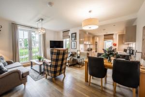 a living room with a kitchen and a dining room at Royal Golf Apartments in Dornoch