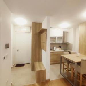 a kitchen and dining room with a table and a dining room at Duki1 in Novi Beograd