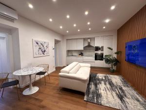a living room with a white couch and a table at Residenza Ricci & Spa in Foggia