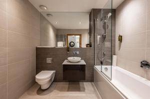 a bathroom with a toilet and a sink and a shower at Royal Golf Apartments in Dornoch +186 photos