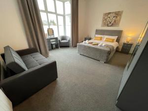 a large bedroom with a bed and a couch at Lovely Apartment in Cleethorpes (sleeps up-to 10) in Cleethorpes