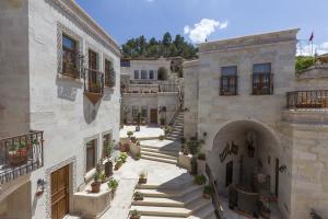 an old building with stairs in a courtyard at Magic Cave House in Ürgüp
