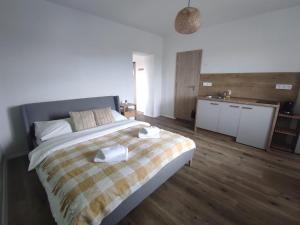 a bedroom with a large bed and a kitchen at Symple apartments in Košice