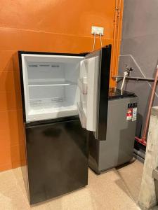a small refrigerator with its door open in a room at 56 Glory 3min to beach private swimming pool BBQ Steamboat in Port Dickson +34 photos