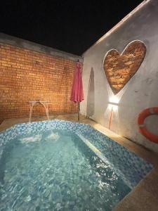 a large swimming pool with a heart on the wall at 56 Glory 3min to beach private swimming pool BBQ Steamboat in Port Dickson