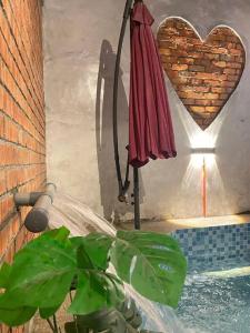 a red umbrella and a heart on a wall at 56 Glory 3min to beach private swimming pool BBQ Steamboat in Port Dickson