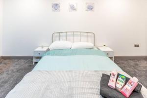 a bedroom with a bed with two books on it at Cosy 2 Bedroom Flat in Bradford, on street parking in Bradford