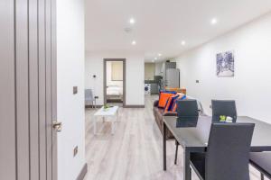 a living room with a table and a couch at Cosy 2 Bedroom Flat in Bradford, on street parking in Bradford