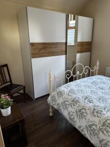 1 dormitorio con cama, silla y espejo en Cosy barn conversion in the Mournes, en Newry