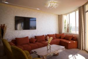 a living room with a couch and a table at Villa Mogador By Solena in Essaouira