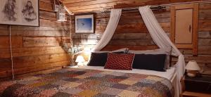 a bedroom with a bed in a log cabin at Korvala log cabins in Korvala