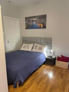 a bedroom with a bed with a blue blanket at Stylish Studio in Montrose - The Italian Plaza in Houston