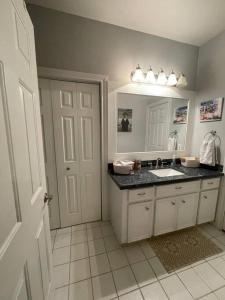 a bathroom with a sink and a mirror at Stylish Studio in Montrose - The Italian Plaza in Houston