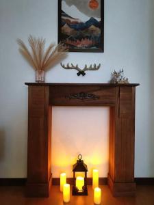 a fireplace with candles in a living room at Happy Guest Apartments - Central Living Borno in Borno