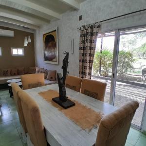 a dining room with a wooden table and chairs at El Cimarron Casa de Campo in La Granja