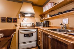 a kitchen with a sink and a stove top oven at Le Cartier Bed and Breakfast in Montreal