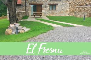 a bench in front of a stone building with grass at Apartamentos Rurales Casa la Piedra in Collía