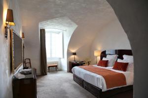 a bedroom with a large bed and a window at Château de Mercuès in Mercuès