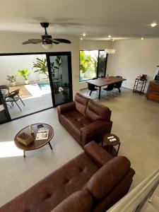 a living room with a couch and a table at Solemar 2bdrm House - Private Pool , King Bed and Balcony Sunset View in Mal País