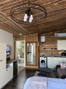 a living room with a bed and a mirror at Sea View Cabin in Alexandria