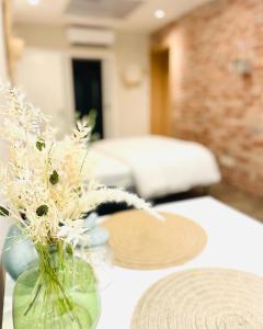 a vase with white flowers sitting on a table at La petite halte in Godshuis