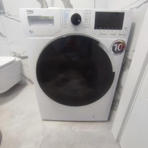 a white washing machine sitting in a room at Duki1 in Novi Beograd