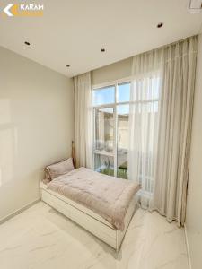 a bedroom with a bed and a large window at كرم شاليه in Barka +21 photos