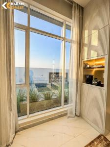 a large window with a view of the ocean at كرم شاليه in Barka