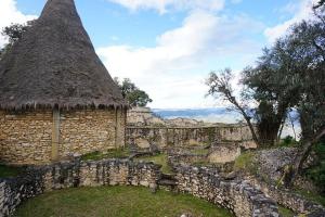 a stone building with a grass roof and a stone wall at HOTEL VIP 46 SSQS in Bagua Grande