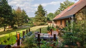 a house with a fence next to a yard at Villa Warminska in Kręsk
