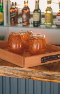 a tray with three glasses of honey on a counter at Domos Park in Mar de las Pampas