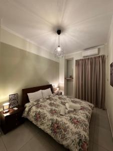 a bedroom with a large bed and a lamp at Mairas Ηouse in Piraeus