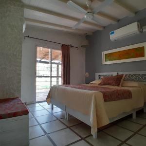 a bedroom with a large bed and a window at El Cimarron Casa de Campo in La Granja