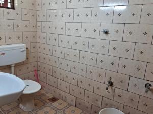 a bathroom with a toilet and a sink at Homely Home stay in Kalpetta