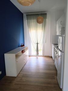 a kitchen with a white counter and a window at Trilo Lorenzo - In centro ed a soli 30 m dal mare in Numana